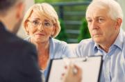 Senior couple talking with financial advisor